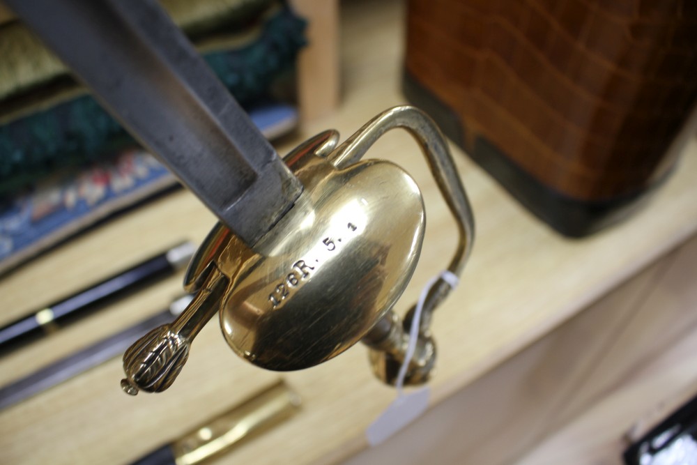 A Victorian brass hilted sword, the hilt stamped 126R.5.1 and a brass and plate mounted ebony swordstick